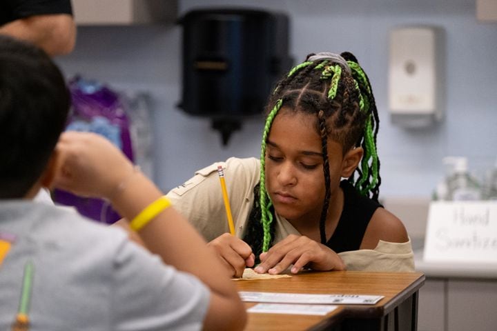 Hope Wiggins, 10, works on a letter to her future self on the first day of class at Compton Elementary School in Powder Springs on Tuesday, Aug. 1, 2023.   (Ben Gray / Ben@BenGray.com)