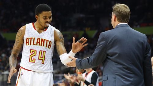 Hawks Kent Bazemore gives head coach Mike Budenholzer five during the final minute of a 102-98 victory over the Knicks in a NBA basketball game on Wednesday, Dec. 28, 2016, in Atlanta. Curtis Compton/ccompton@ajc.com