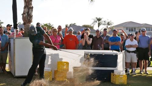Tiger Woods' adventures in driving leads him to a second shot out of a concession area Thursday at the Honda Classic. (AP Photo/Wilfredo Lee)