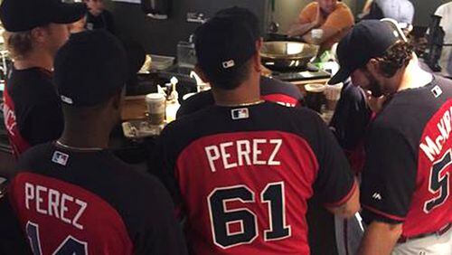 Braves rookies await coffee order Sunday at Starbucks across from Wrigley Field in Chicago.