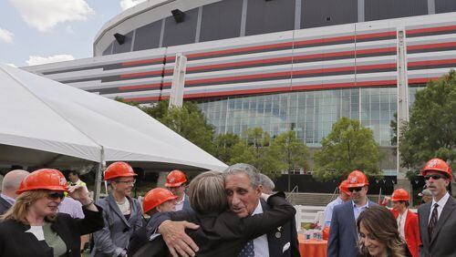 April 21, 2017 - Atlanta - Arthur Blank (center) joins a group from Home Depot for a photo at the announcement of the new greenspace. The opening of the new Mercedes-Benz Stadium may have been moved back again, but the Atlanta Falcons are looking ahead at greenspace that will be created by the demolition of the Georgia Dome. The team unveiled plans for the “Home Depot Backyard” Friday. Arthur Blank was in attendance along with Mayor Kasim Reed, Home Depot CEO Craig Menear, GWCCA Chairman David Allman and Frank Fernandez, VP of Community Development for The Arthur M. Blank Family Foundation. BOB ANDRES /BANDRES@AJC.COM