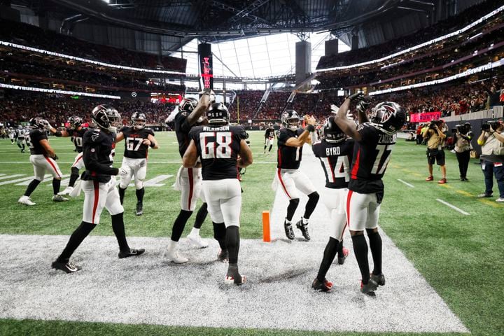 Falcons players celebrate with wide receiver Damiere Byrd after his fourth-quarter touchdown Sunday against the Panthers. (Miguel Martinez / miguel.martinezjimenez@ajc.com)
