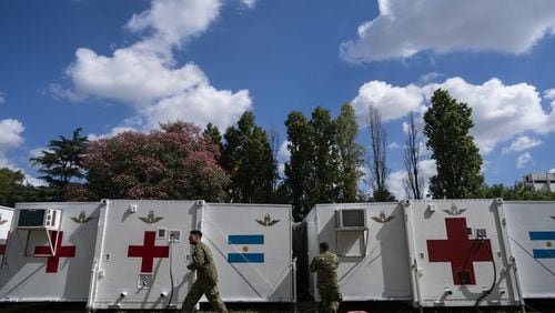 Military personnel do maintenance work on a mobile hospital in Buenos Aires, Argentina, Friday, April 3, 2020. The Air Force there has set up this mobile hospital in case it’s needed to aid people infected with COVID-19. (AP Photo/Victor R. Caivano)