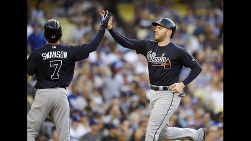 Dansby Swanson and Freddie Freeman (right) both scored on a two-out double from Tyler Flowers in Saturday night’s 5-3 win against the Dodgers. (AP Photo/Mark J. Terrill)