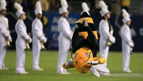 Georgia Tech mascot Buzz does a flip as the band takes the field before playing Virginia Tech Thursday, Nov. 12, 2015, in Atlanta.