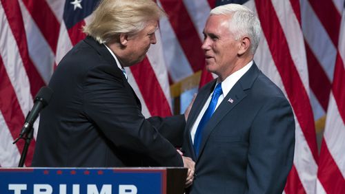 Republican presidential candidate Donald Trump, left, shakes hands with Gov. Mike Pence, R-Ind., during a campaign event to announce Pence as the vice presidential running mate on Saturday in New York. AP/Evan Vucci
