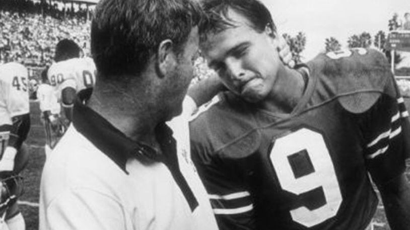 Miami quarterback Mark Richt is consoled by Florida State head coach Bobby Bowden after the Seminoles defeated the Hurricanes 24-7 in 1982.