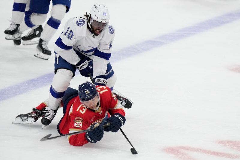 Florida Panthers center Sam Reinhart (13) and Tampa Bay Lightning left wing Anthony Duclair (10) battle for the puck during the second period of Game 1 of the first-round of an NHL Stanley Cup Playoff series, Sunday, April 21, 2024, in Sunrise, Fla. (AP Photo/Wilfredo Lee)