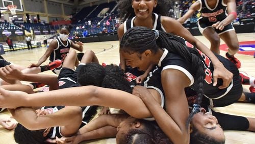 Let's celebrate: Woodward Academy players celebrate their 62-59 victory over Forest Park Thursday in the Class 5A girls state championship game in Macon.