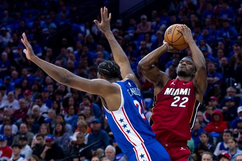 Miami Heat's Jimmy Butler, right, shoots as he is fouled by Philadelphia 76ers' Joel Embiid during the first half of an NBA basketball play-in tournament game Wednesday, April 17, 2024, in Philadelphia. (AP Photo/Chris Szagola)