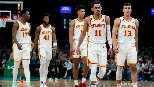 Atlanta Hawks players, from left, Onyeka Okongwu, Saddiq Bey, Jalen Johnson, Trae Young and Bogdan Bogdanovic walk to the bench at the end of the third quarter in Game 1 in the first round of the NBA basketball playoffs, Saturday, April 15, 2023, in Boston. (AP Photo/Michael Dwyer)