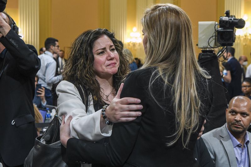 Sandra Garza, left, embraces Capitol Police Officer Caroline Edwards after she testified at the first public hearing before the U.S. House committee investigating the Jan. 6, 2021, attack on the U.S. Capitol. Garza's boyfriend, Capitol Police Officer Brian Sicknick, died the day after the attack. (Kenny Holston/The New York Times)