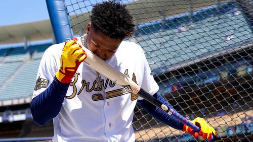 National League's Ronald Acuna, of the Braves, kisses his bat during batting practice before the MLB All-Star baseball game, Tuesday, July 19, 2022, in Los Angeles. (AP Photo/Abbie Parr)