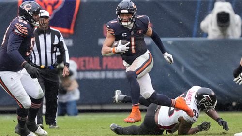 Chicago Bears quarterback Justin Fields (1) breaks away in the second half of an NFL football game against the Atlanta Falcons in Chicago, Sunday, Dec. 31, 2023. (AP Photo/Charles Rex Arbogast)