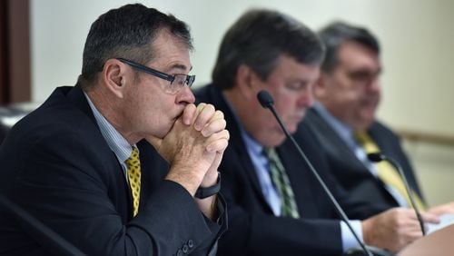 Commissioner Tim Echols (left) listens during Georgia Public Service Commission meeting on Dec. 21, 2017 before the commission voted unanimously to allow continued construction of two nuclear reactors at Georgia Power’s embattled Plant Vogtle, which is billions of dollars over budget and years behind schedule. Hyosub Shin / hshin@ajc.com