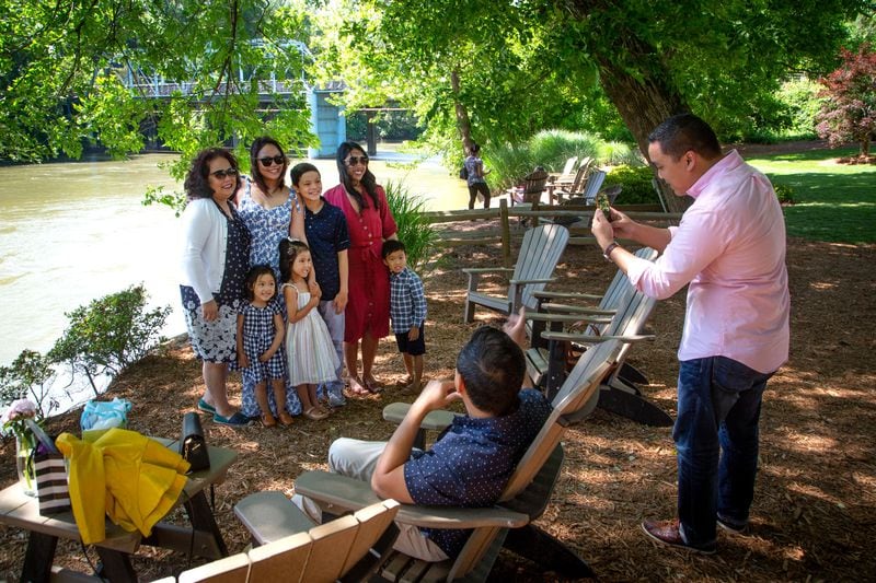 The Nguyen family poses for photographs while waiting for a table at The Canoe restaurant on Mother's Day on Sunday, May 9, 2021. (Photo: Steve Schaefer for The Atlanta Journal-Constitution)