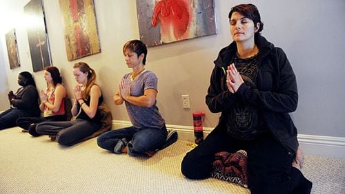 Colleen Comerford (right) meditates in a beginner's meditation class at Kashi Atlanta.