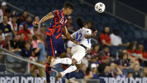 U.S. defender Miles Robinson (left) Martinique forward Johnny Marajo go up for the ball during the first half of a CONCACAF Gold Cup soccer match in Kansas City, Kan., Thursday, July 15, 2021. (AP Photo/Colin E. Braley)