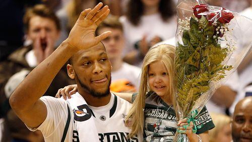 Adreian Payne #5 of the Michigan State Spartans walks on the floor for Senior night with Lacey Holsworth after defeating the Iowa Hawkeyes 86-76 at the Jack T. Breslin Student Events Center on February 6, 2014 in East Lansing, Michigan. (Photo by Gregory Shamus/Getty Images)