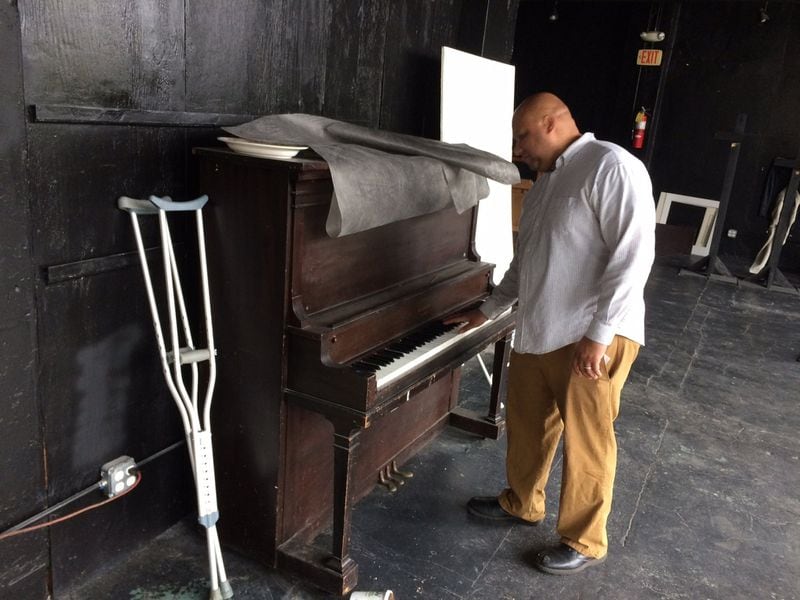 George Chidi, pointman on homelessness for Central Atlanta Progress, examines a piano at the now-closed Peachtree-Pine shelter.