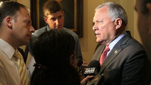 Gov. Nathan Deal talks to reporters Thursday about allegations that the head of the state ethics commission intervened on his behalf during an investigation.