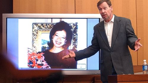 Phillip Anthony "Tony" Harwood testifies in March 2006 in the murder trial of James Vincent Sullivan. Sullivan was convicted of hiring Harwood in the January 1987 contract murder of Lita McClinton Sullivan (pictured on the screen). Harwood was sentenced to 20 years after pleading guilty to voluntary manslaughter and agreeing to testify against James Sullivan. BITA HONARVAR/ AJC / 2006 file photo
