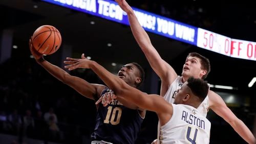 Notre Dame guard TJ Gibbs (10) is defended by Georgia Tech's Ben Lammers and Brandon Alston (4) as he drives to the basket during the first half of an NCAA college basketball game Wednesday, Jan. 10, 2018, in Atlanta. (AP Photo/John Bazemore)