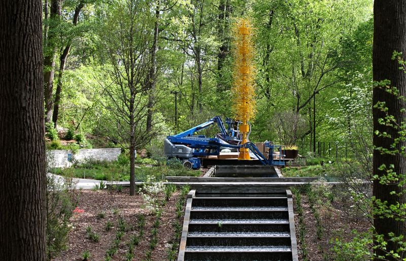 Workers installed Dale Chihuly's "Saffron Tower" in the Storza Woods during the Atlanta Botanical Garden’s 2016 exhibit of the artist’s works. TAYLOR CARPENTER / TAYLOR.CARPENTER@AJC.COM