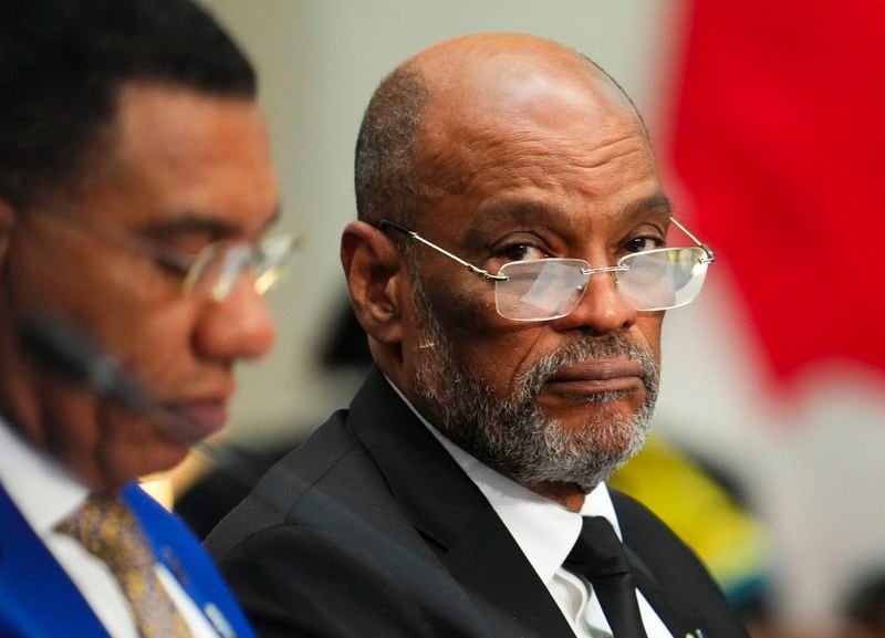 FILE - Haiti's Prime Minister Ariel Henry, right, attends a working session at the Canada-CARICOM Summit in Ottawa, Ontario, Oct. 18, 2023. Henry resigned on April 25, 2024, leaving the way clear for a new government to be formed in the Caribbean country. (Sean Kilpatrick/The Canadian Press via AP, File)