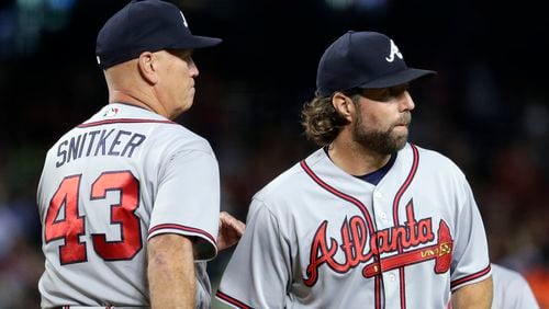 Braves starting pitcher R.A. Dickey (right) is pulled by manager Brian Snitker during the fourth inning against the Arizona Diamondbacks, Monday, July 24, 2017, in Phoenix.