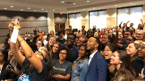 John Legend poses for a selfie with Georgia Tech students during a campaign stop for Democrat Stacey Abrams. Bria Felicien/AJC