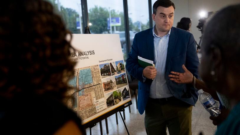 Jon Tuley, a consultant for MARTA, speaks Tuesday to community members in front of informational displays that give details about bringing a bus rapid transit project to a 6-mile stretch along Campbellton Road in southwest Atlanta. About 40 people attended the meeting. (Chris Day/Christopher.Day@ajc.com)
