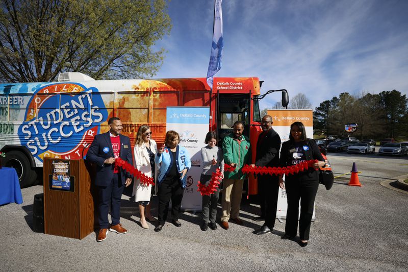 Vasanne S. Tinsley, Interim Superintendent of Dekalb County Public Schools (third on the left), cuts the ribbon during the new Students Success Mobile Center unveiling at Lithonia High School on Wednesday, March 29, 2023. Miguel Martinez / miguel.martinezjimenez@ajc.com