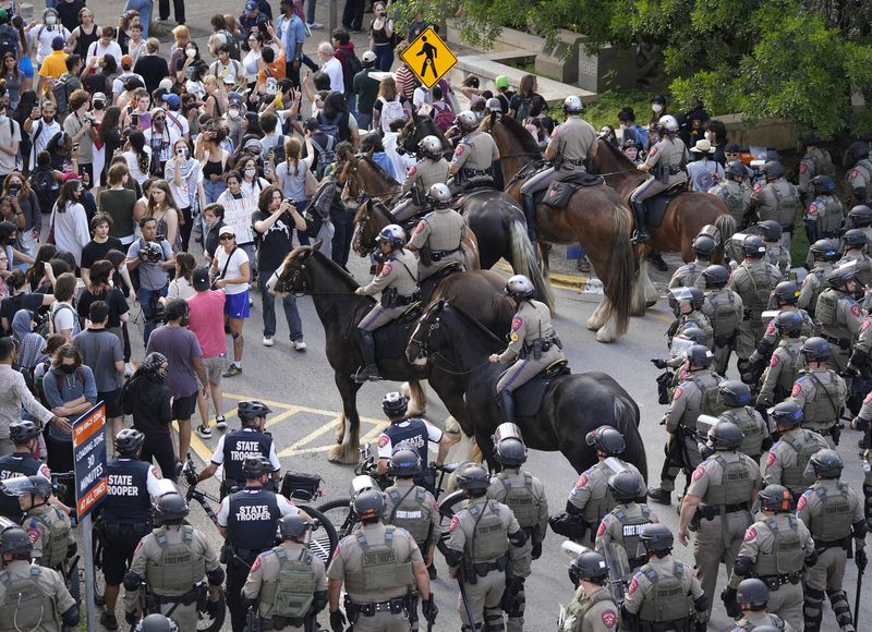 State troopers try to break up a pro-Palestinian protest at the University of Texas Wednesday April 24, 2024, in Austin, Texas. Student protests over the Israel-Hamas war have popped up on an increasing number of college campuses following last week's arrest of more than 100 demonstrators at Columbia University. (Jay Janner/Austin American-Statesman via AP)
