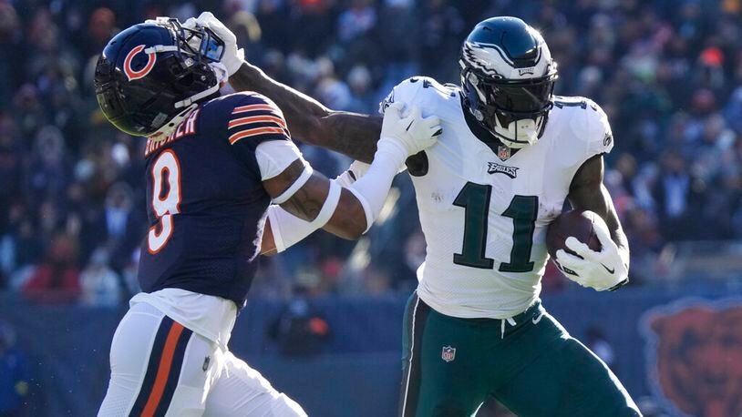 Philadelphia Eagles' A.J. Brown, right, tries to get past Chicago Bears' Jaquan Brisker during the first half of an NFL football game against the Chicago Bears, Sunday, Dec. 18, 2022, in Chicago. (AP Photo/Nam Y. Huh)