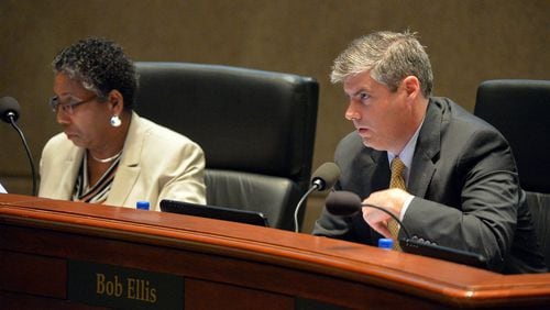 Fulton County Vice Chairman Bob Ellis, seated next to deceased Commissioner Joan Garner, said he will work hard to reach consensus now that the board is down by two people. KENT D. JOHNSON/ AJC FILE PHOTO