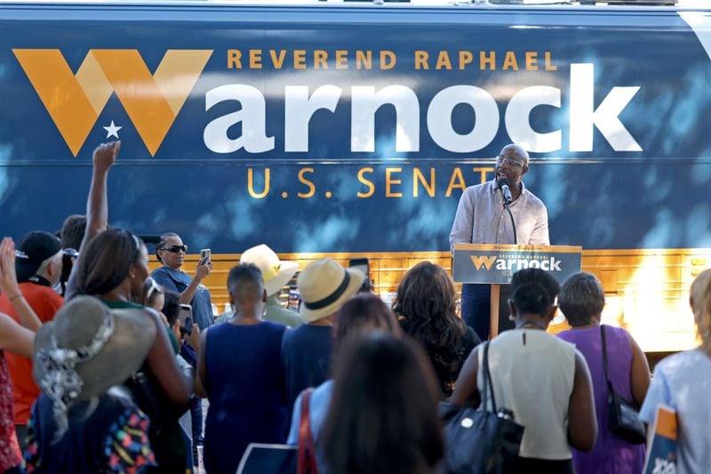 Democratic U.S. Sen. Raphael Warnock greets supporters Wednesday during a campaign stop at the Cobb County Civic Center. Stacey Abrams, the Democratic nominee for governor, also spoke at the rally. (Jason Getz / Jason.Getz@ajc.com)
