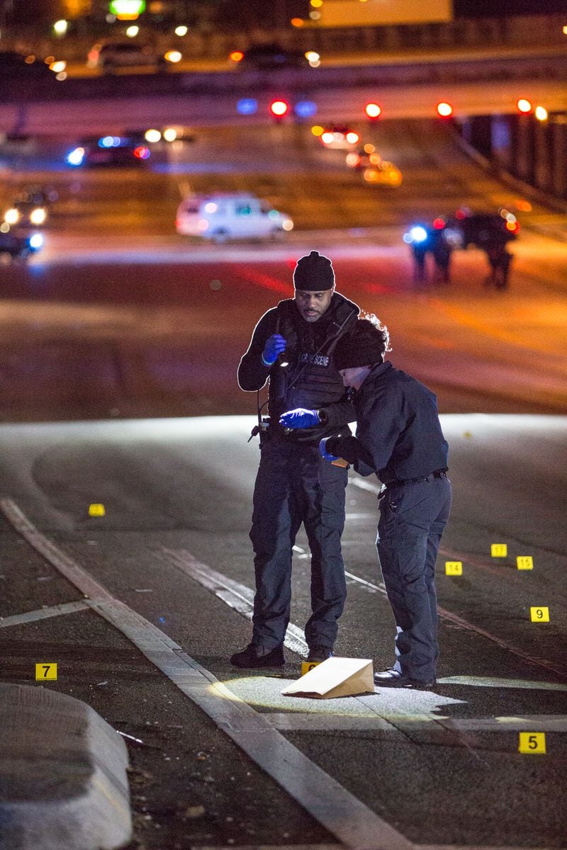 Atlanta police investigate a scene on Cheshire Bridge Road after two men were found shot to death in a car.