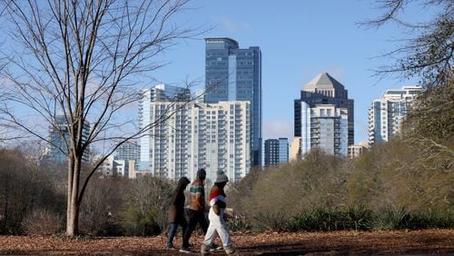 The holiday weekend saw wind chills below zero in metro Atlanta and North Georgia. On Friday, people braved the cold to take a walk around Lake Clara Meer as the Midtown skyline is shown at Piedmont Park. (Photo: Jason Getz / Jason.Getz@ajc.com)
