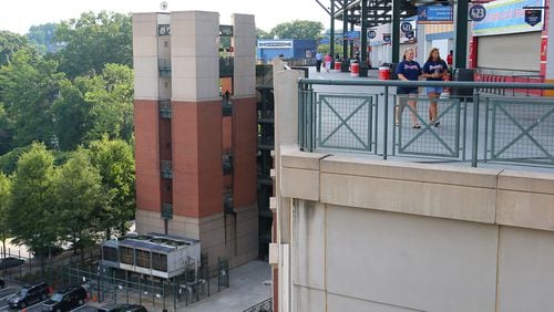 A baseball fan fell from the upper deck at Turner Field stadium (near the red sign at the top of a stairwell at far left) near the edge of the player's parking lot (bottom left) during the game last night as fans begin to arrive for today's game at Turner Field on Tuesday Aug. 13, 2013 in Atlanta.