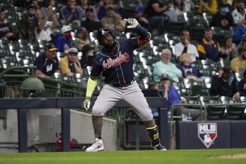 Atlanta Braves' Marcell Ozuna pauses at third for a simulated selfie photo after hitting a home run during the fifth inning of a game against the Milwaukee Brewers Friday, May 14, 2021, in Milwaukee. (AP Photo/Morry Gash)