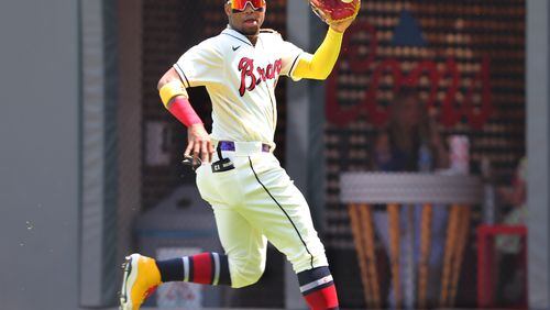 Braves outfielder Ronald Acuna catches a fly ball during a May 2021 game against the Pittsburgh Pirates at Truist Park in Atlanta. (AJC file photo/ccompton@ajc.com)
