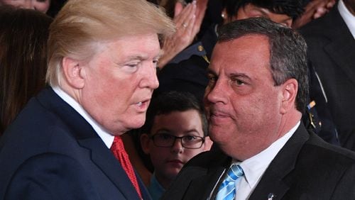 US President Donald Trump, left, speaks with Governor Chris Christie (R-NJ) after he delivered remarks on combatting drug demand and the opioid crisis on October 26, 2017 in the East Room of the White House in Washington, D.C. (Jim Watson/AFP/Getty Images/TNS)