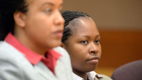 Former APS Dunbar Elementary teacher Shani Robinson (right) listens to appeals in her case during sentencing.