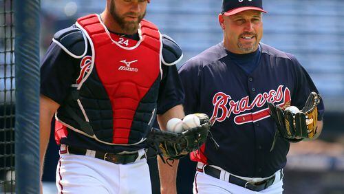 Braves catcher Evan Gattis works with team manager Fredi Gonzalez during batting practice before the Braves play the Pirates on Tuesday, June 4 , 2013, in Atlanta.