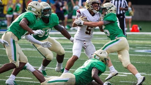 Tucker running back Tyler Hughey is tackled by Buford's Hayden Olsen during the 2018  Corky Kell Classic Friday, Aug.17, 2018, at Georgia State Stadium in Atlanta.