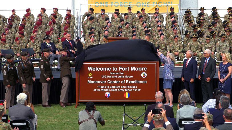 The children of  Lt. Gen. Hal and Julia Moore join the command team at what's now Fort Moore in unveiling the new sign. Fort Benning was redesignated as Fort Moore during a recent ceremony at Doughboy Stadium. (Photo Courtesy of Mike Haskey/The Ledger-Enquirer)