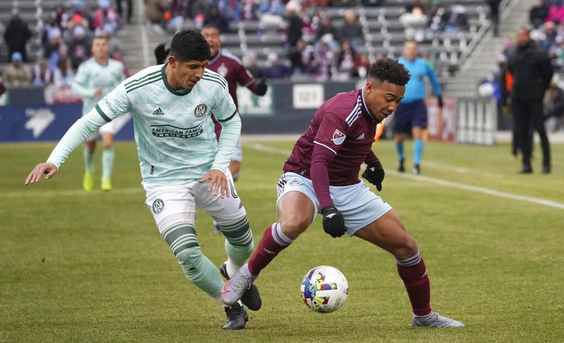 Atlanta United's Alan Franco, left, vies for control of the ball with Colorado Rapids' Jonathan Lewis during the first half of an MLS soccer match Saturday, March 5, 2022, in Commerce City, Colo. (AP Photo/David Zalubowski)