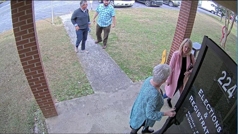 Cathy Latham, a Republican who tried to cast Georgia's electoral votes for Donald Trump, opens the door for members of SullivanStrickler, an Atlanta tech firm that copied election data on Jan. 7, 2021. From left: Paul Maggio, Jim Nelson, Latham and Jennifer Jackson.