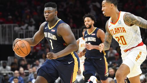 New Orleans Pelicans forward Zion Williamson (1) takes his steal up the floor as Atlanta Hawks forward John Collins (20) follows during the second half of an exhibition basketball game, Monday, Oct. 7, 2019, in Atlanta. The Pelicans won 133-109. (Special/John Amis)